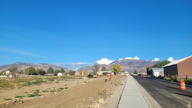 2730 West Rodeo Drive, Unit 2 West Haven, UT 84401 - Photo 2 of 4 View of asphalt street featuring a mountain view and curbs