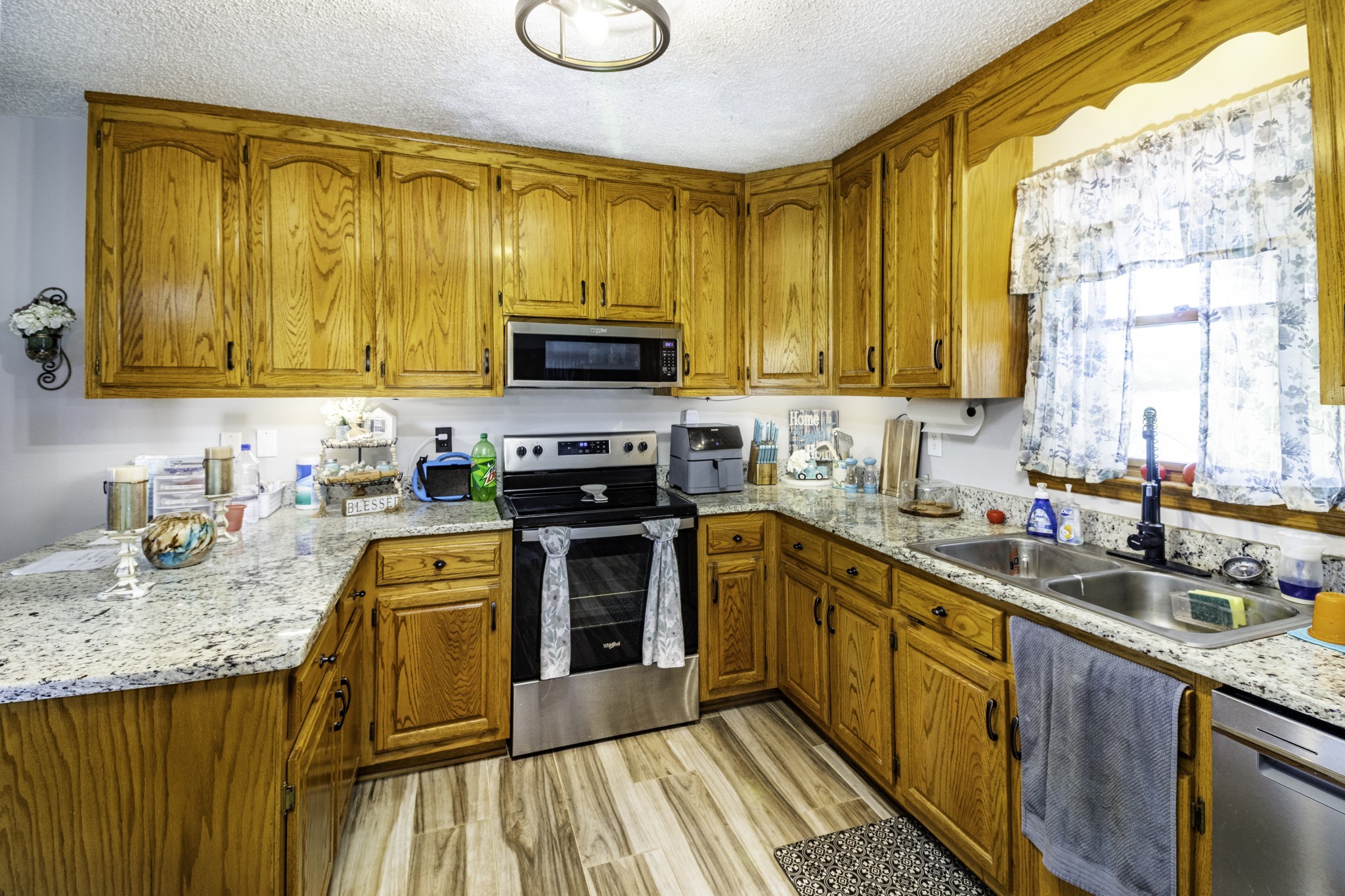 2285 Crescentview Road Pulaski, TN 38478 - Photo 5 of 31 a kitchen with stainless steel appliances granite countertop a stove a sink dishwasher and a microwave oven with cabinets