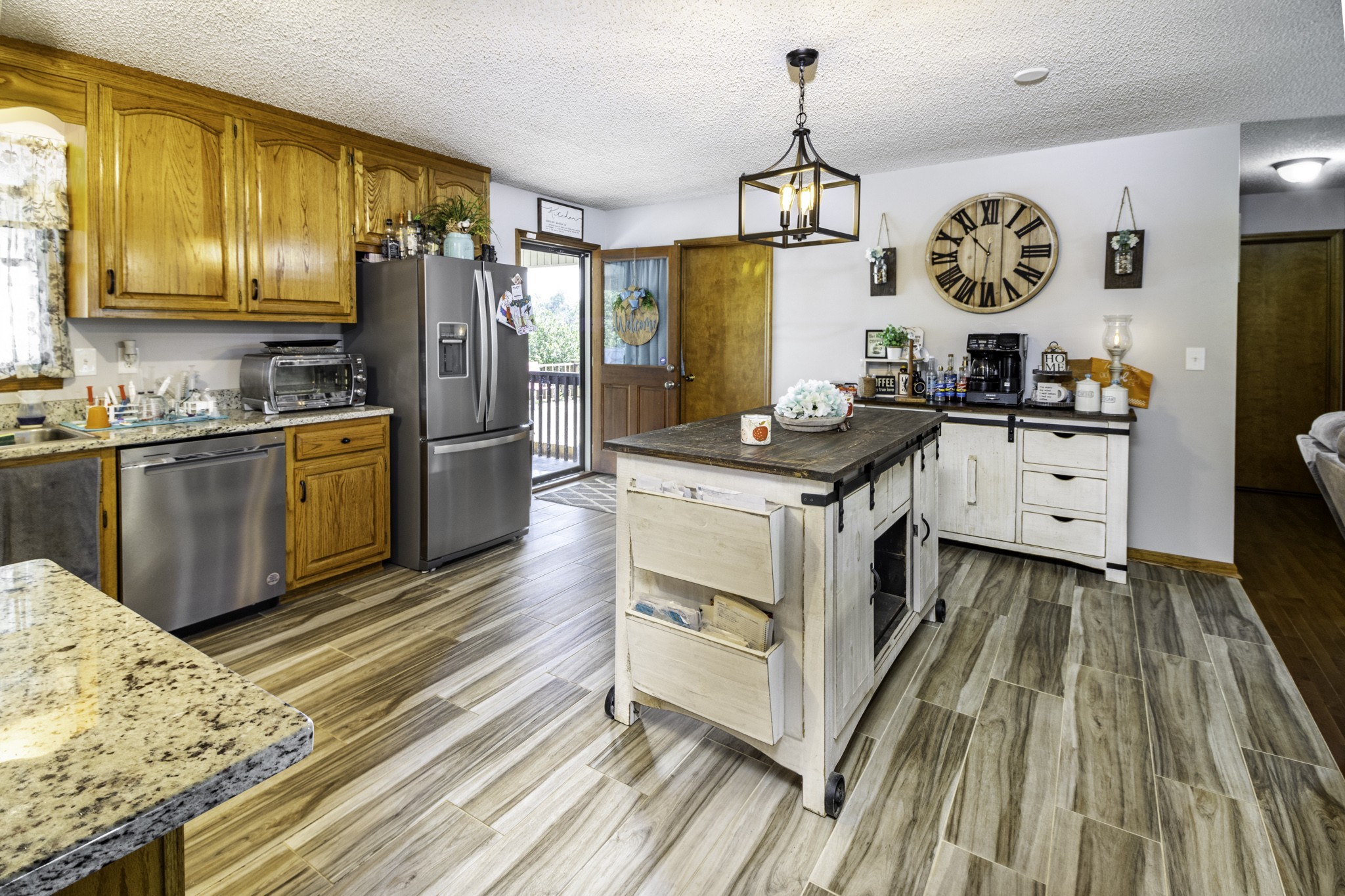 2285 Crescentview Road Pulaski, TN 38478 - Photo 6 of 31 a kitchen with stainless steel appliances granite countertop a stove top oven a refrigerator a sink and dishwasher a oven with wooden floor