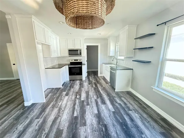 an empty room with closet and fan