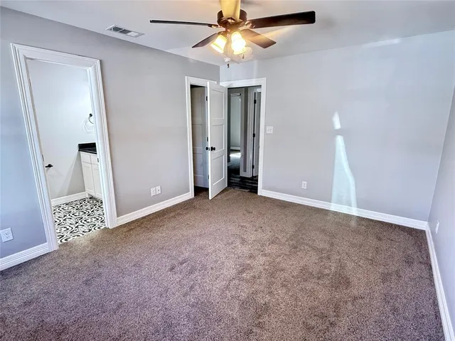 a view of a livingroom with a ceiling fan and window