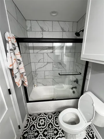 a bathroom with a sink and mirror with toilet
