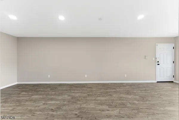 a view of room with wooden floor