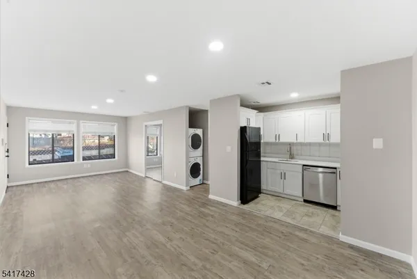 a view of an empty room with a kitchen
