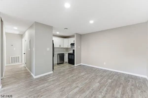 a view of a kitchen with wooden floor