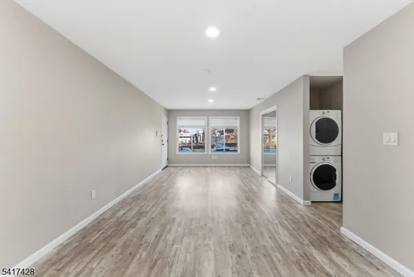 a view of an empty room and wooden floor