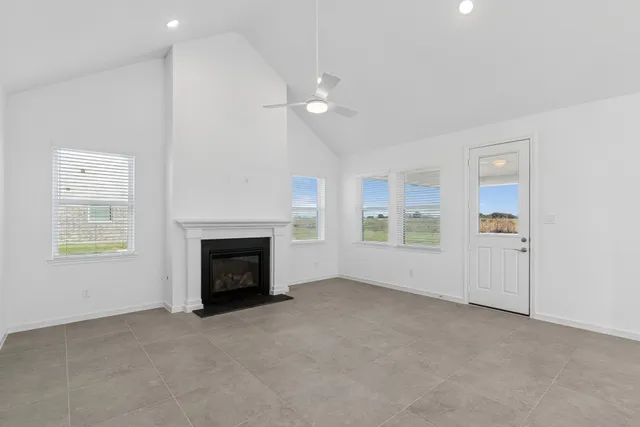a large kitchen with stainless steel appliances a stove a sink and a white cabinets