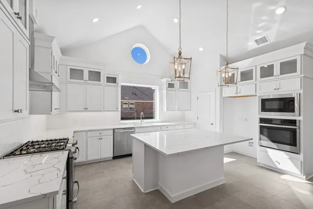 a kitchen with a sink stove and cabinets