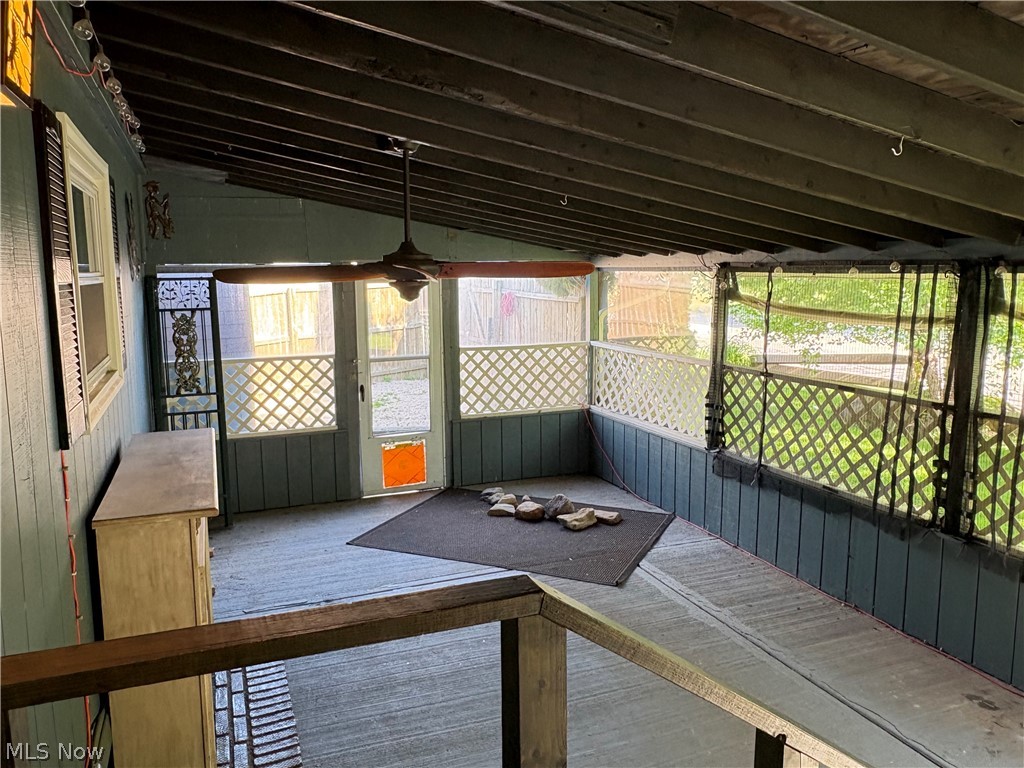 8701 Mayfield Road, Unit 148 Chesterland, OH 44026 - Photo 7 of 22 Screened porch featuring a ceiling fan, lattice panels, and a wood-finish floor