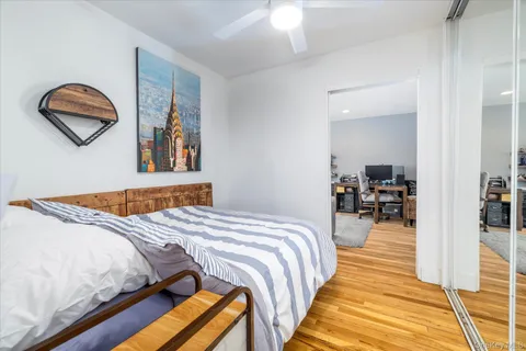 a bedroom with bed and a painting on the wall