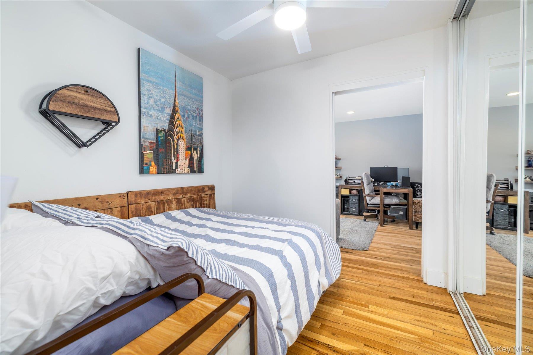 522 Shore Road, Unit 4A Long Beach, NY 11561 - Photo 12 of 32 a bedroom with bed and a painting on the wall