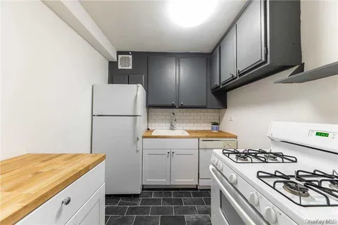 a kitchen with a sink stove and refrigerator