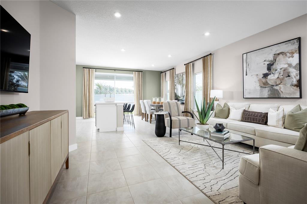 31391 Spanish Msn Road San Antonio, FL 33576 - Photo 3 of 26 a living room with furniture a flat screen tv and a large window