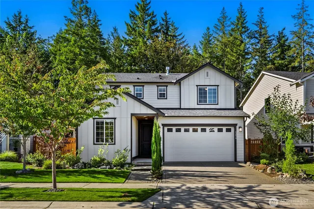 a front view of a house with a garden