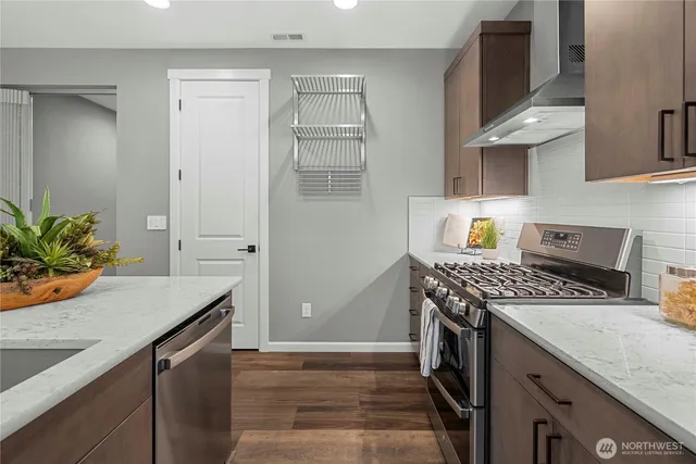 a kitchen with granite countertop a sink stove and cabinets
