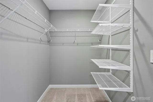 a view of walk in closet with empty racks