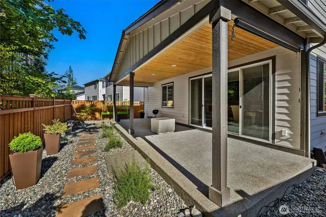 a view of a patio with couches table and chairs and potted plants