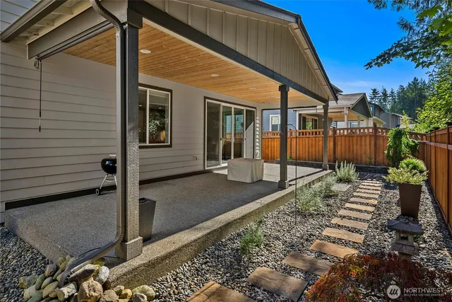 a view of a house with wooden fence next to a road