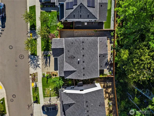 an aerial view of a house with a yard