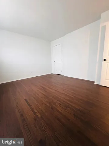 an empty room with wooden floor