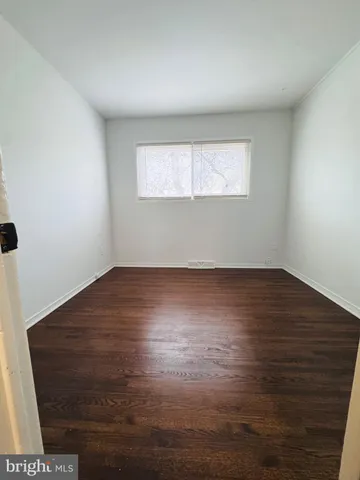 a view of wooden floor and windows in a room