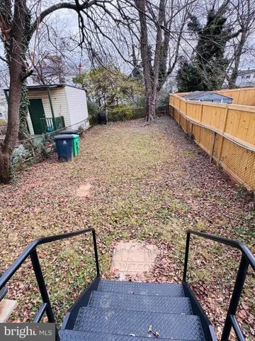 a view of a bench in the backyard