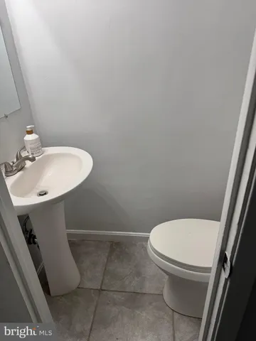 a white toilet sitting next to a white sink