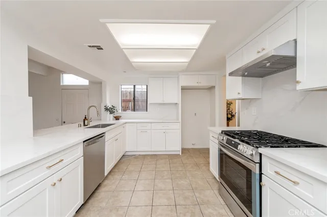 a kitchen with a sink stove and cabinets