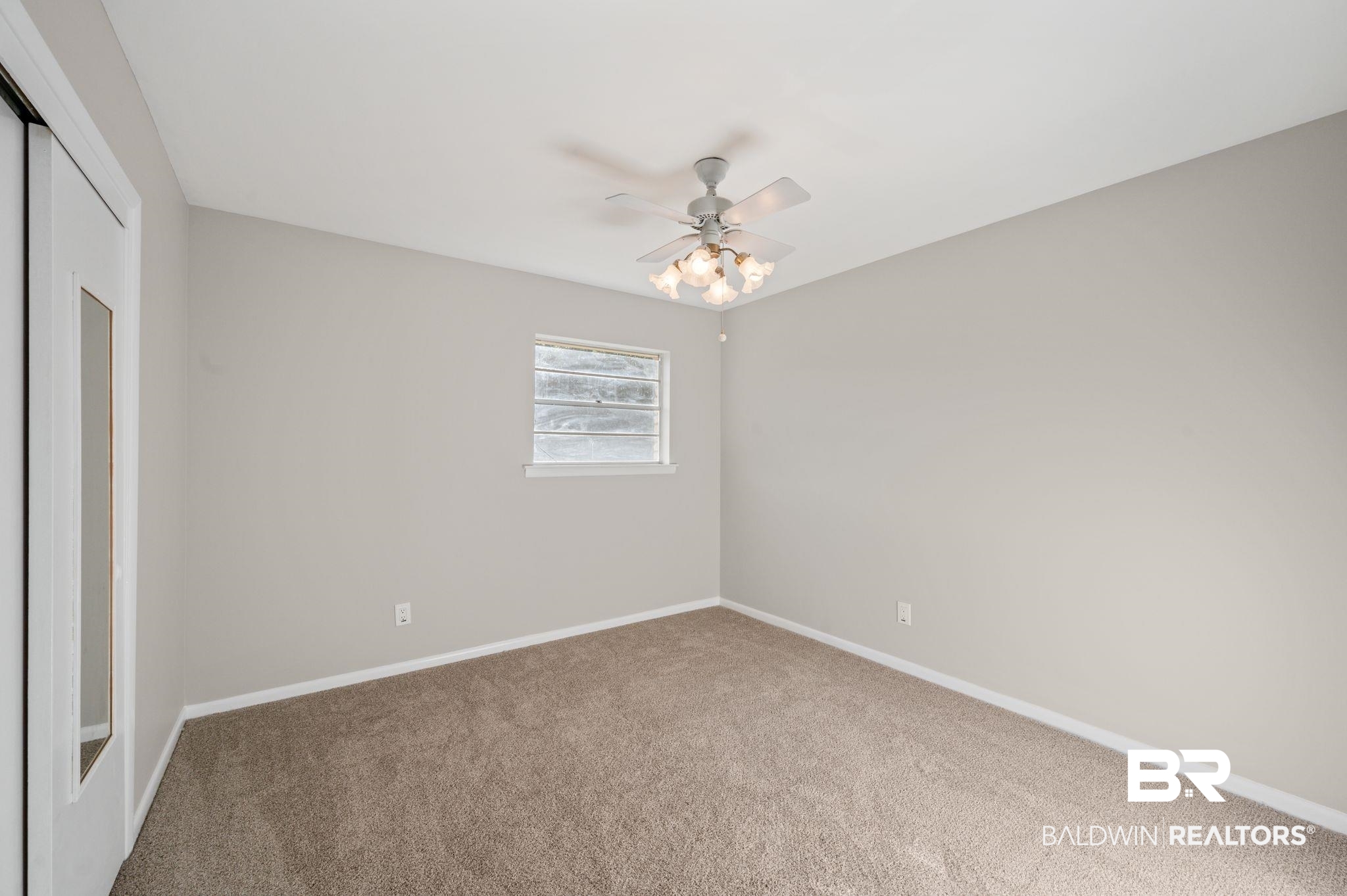 909 Caroline Avenue Daphne, AL 36526 - Photo 27 of 46 Unfurnished bedroom featuring carpet flooring, ceiling fan, and a closet