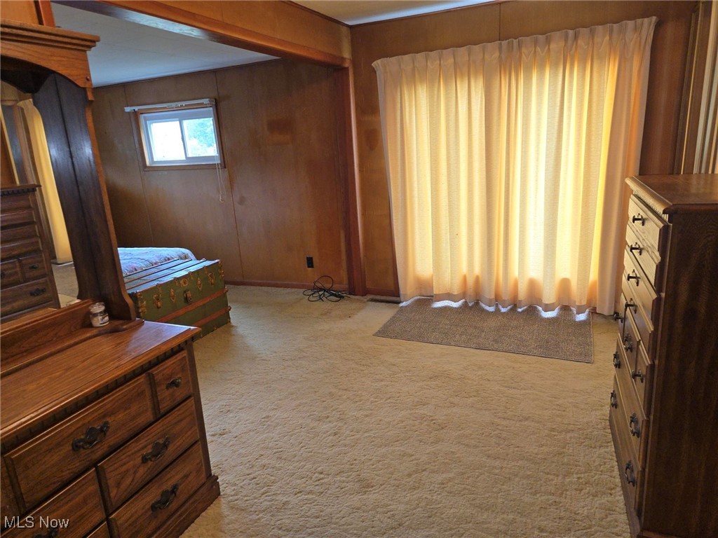 360 Glass Road Malta, OH 43758 - Photo 4 of 32 Bedroom featuring light carpet and wood walls