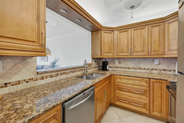 a kitchen with stainless steel appliances granite countertop a sink and cabinets