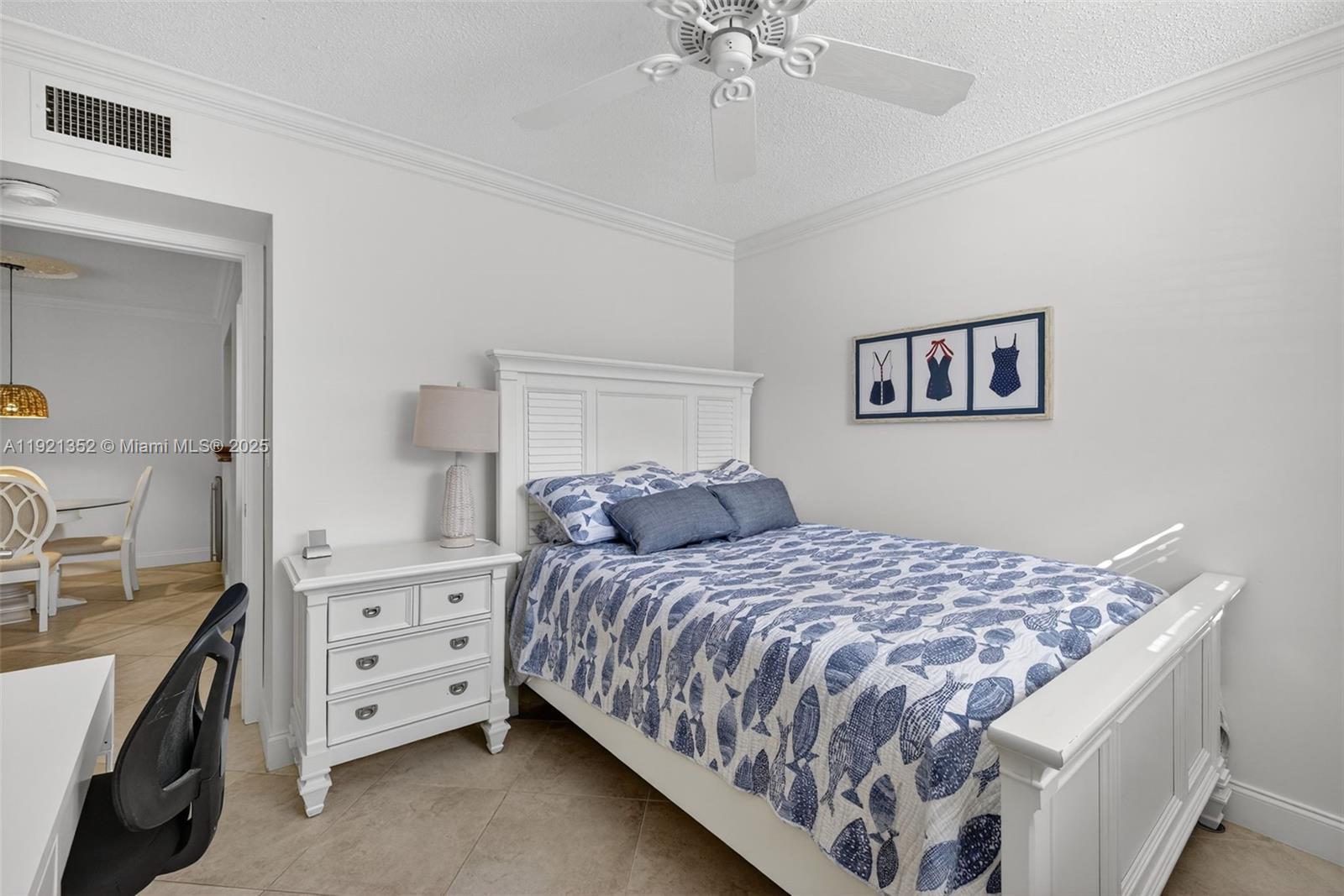 5681 Southwest 2nd Court, Unit 117 Margate, FL 33068 - Photo 13 of 26 a bedroom with a bed and a chandelier