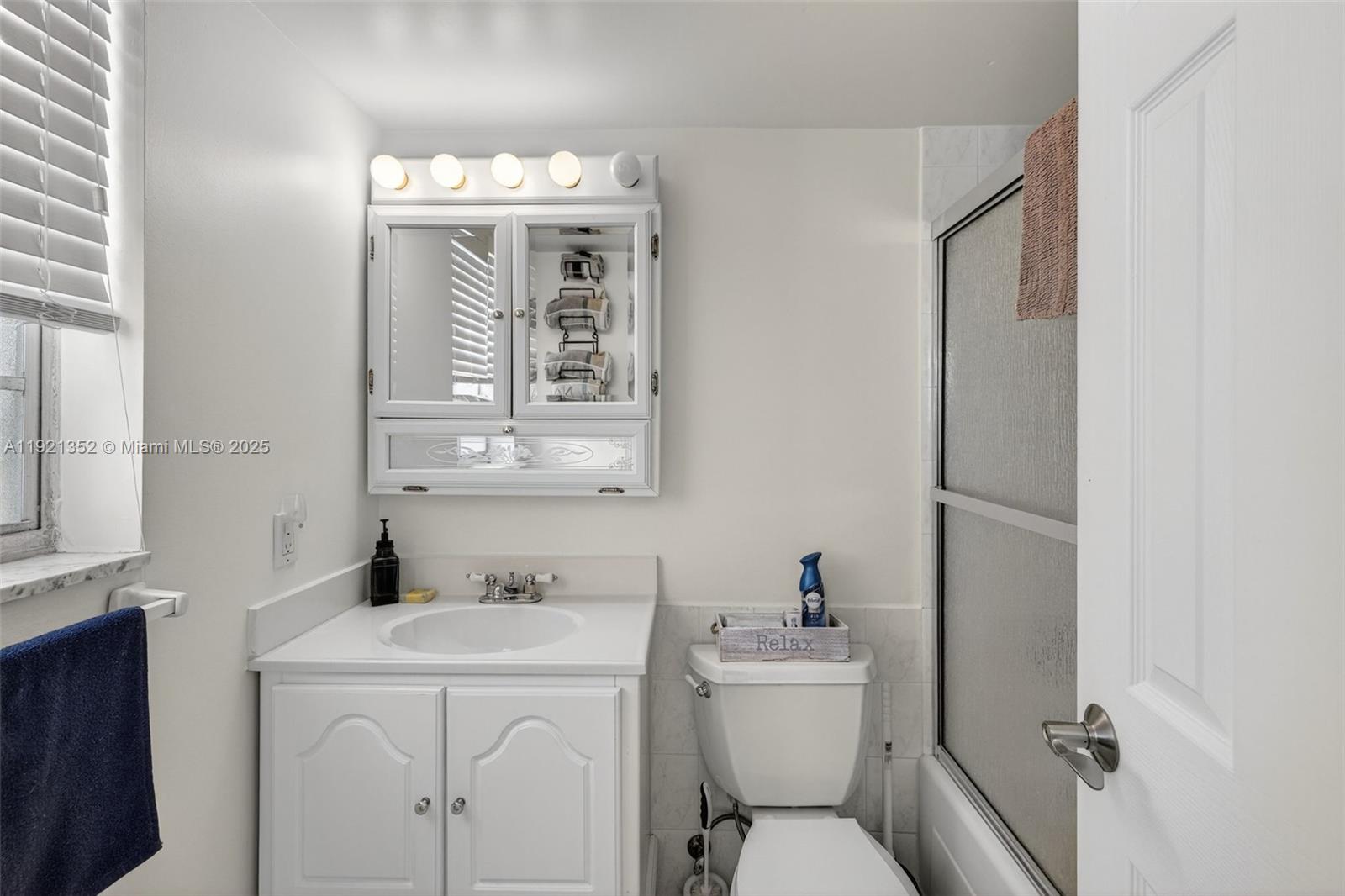 5681 Southwest 2nd Court, Unit 117 Margate, FL 33068 - Photo 14 of 26 a bathroom with a toilet sink and mirror