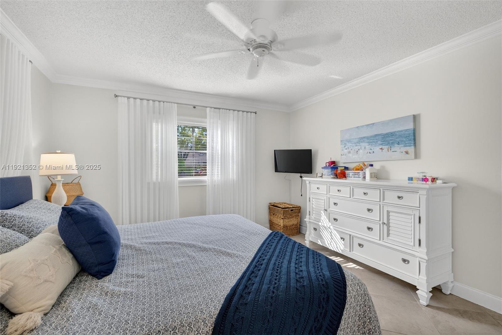 5681 Southwest 2nd Court, Unit 117 Margate, FL 33068 - Photo 17 of 26 a bed room with a bed window and a dresser