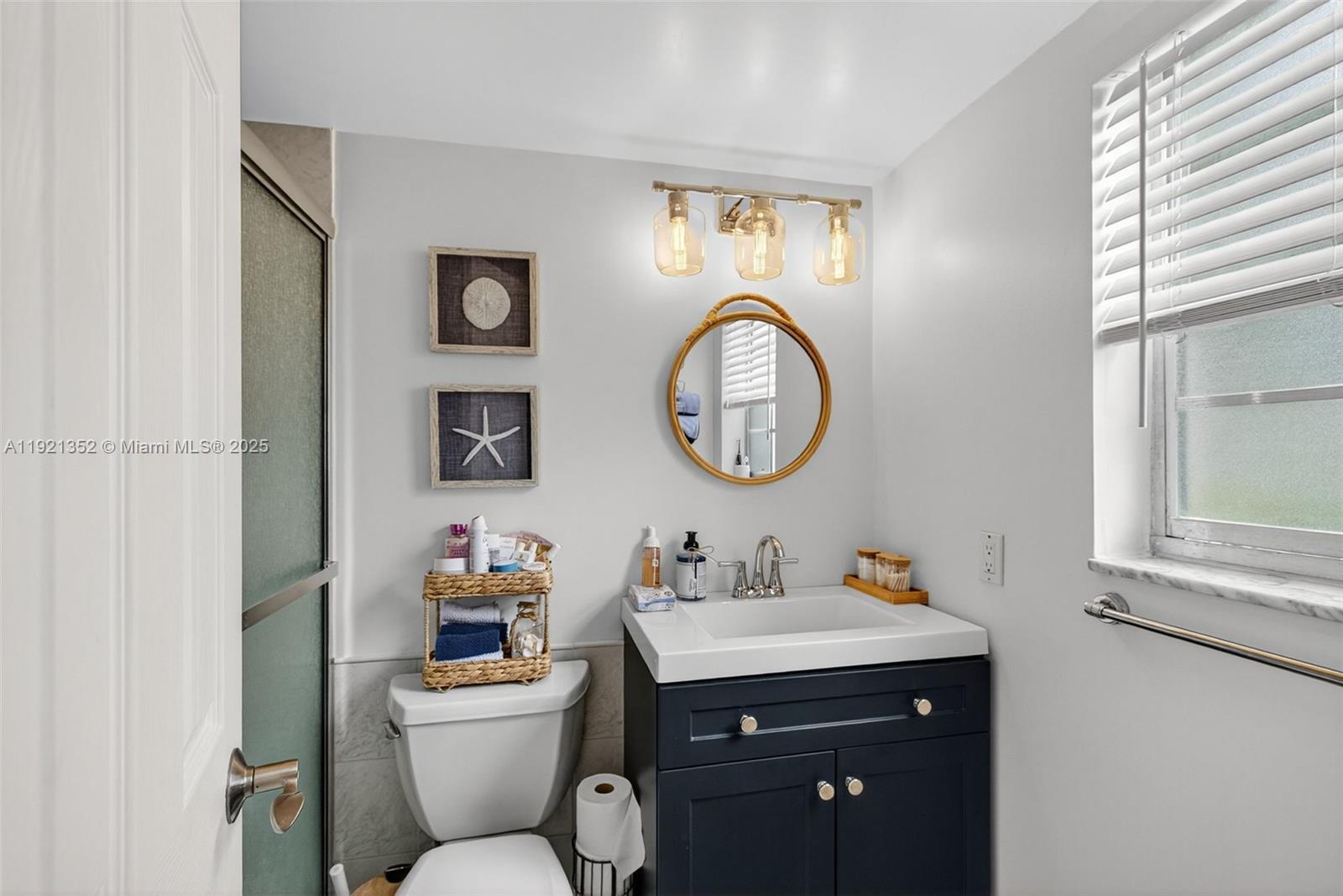 5681 Southwest 2nd Court, Unit 117 Margate, FL 33068 - Photo 18 of 26 a bathroom with a toilet a sink and a mirror