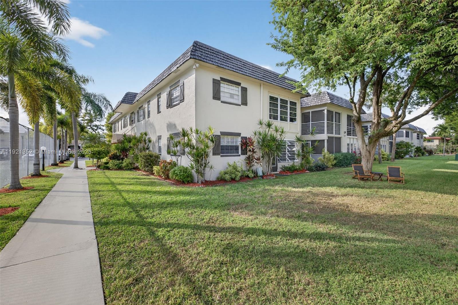 5681 Southwest 2nd Court, Unit 117 Margate, FL 33068 - Photo 24 of 26 a front view of a house with a yard and trees