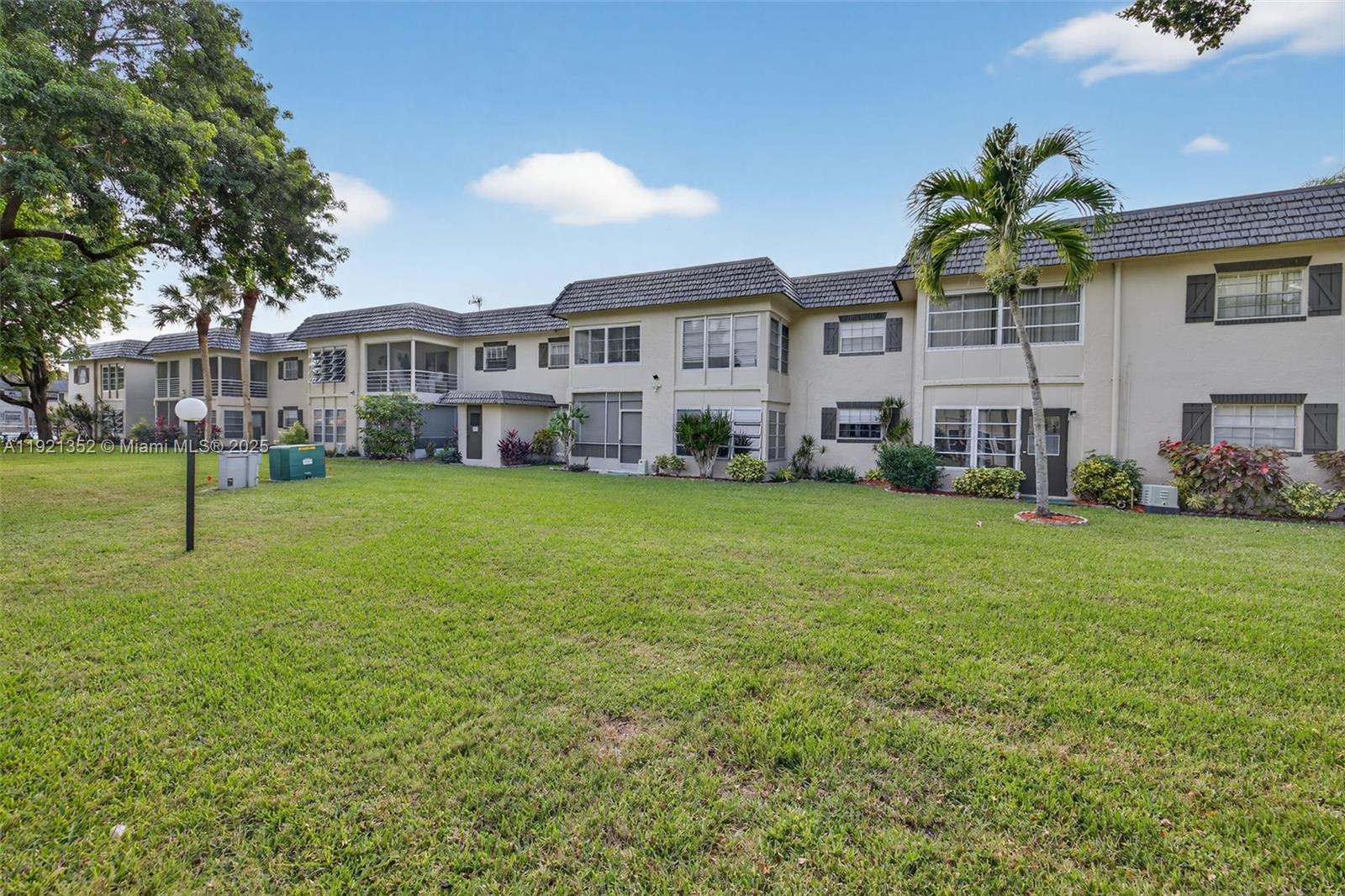 5681 Southwest 2nd Court, Unit 117 Margate, FL 33068 - Photo 25 of 26 a view of a yard with a house in the background