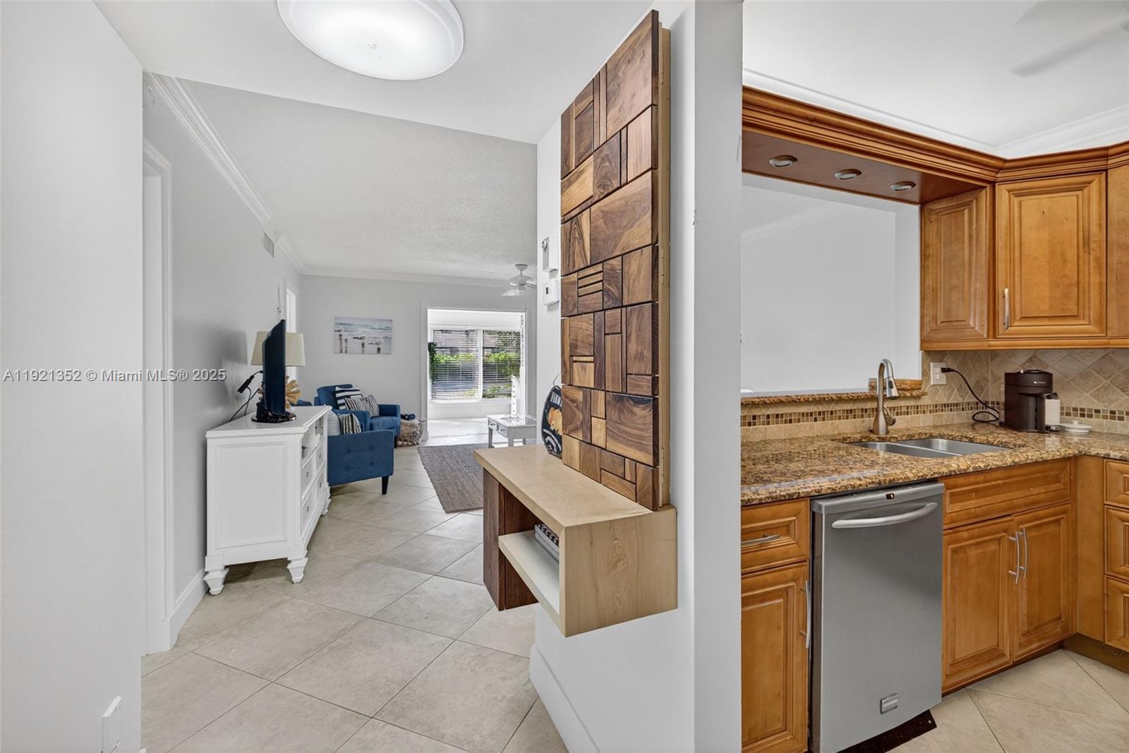 5681 Southwest 2nd Court, Unit 117 Margate, FL 33068 - Photo 3 of 26 a kitchen with a sink stove and cabinets