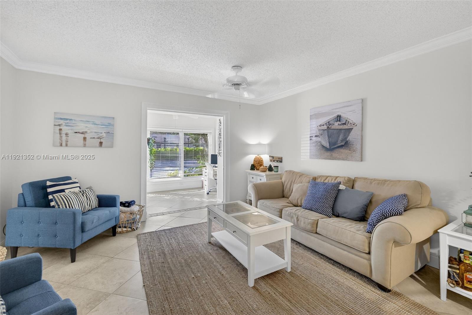 5681 Southwest 2nd Court, Unit 117 Margate, FL 33068 - Photo 5 of 26 a living room with furniture and a large window