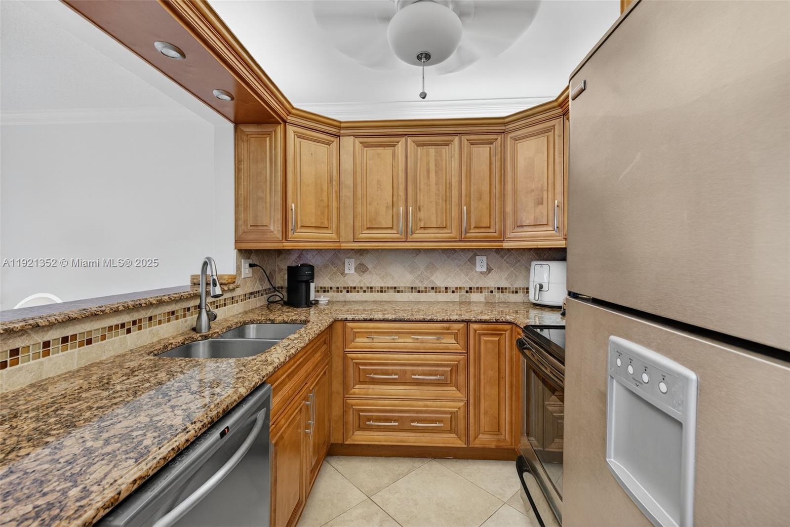 5681 Southwest 2nd Court, Unit 117 Margate, FL 33068 - Photo 10 of 26 a kitchen with granite countertop a sink and cabinets