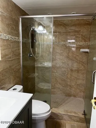 a bathroom with a toilet a sink and shower