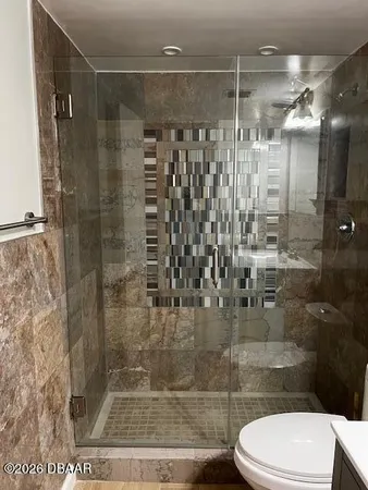 a bathroom with a shower and toilet