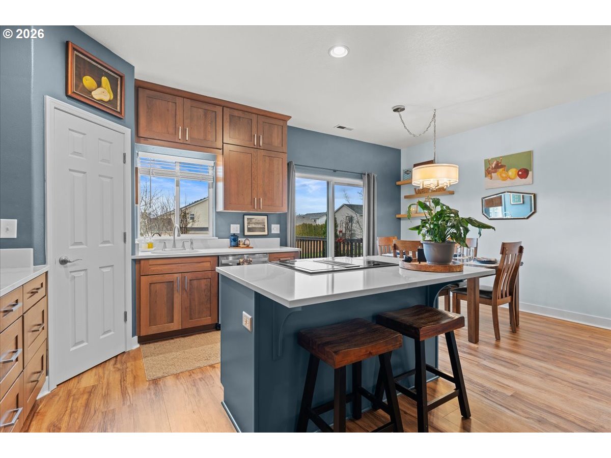 21123 Osburn Loop Fairview, OR 97024 - Photo 12 of 48 a kitchen with stainless steel appliances kitchen island a table and chairs in it