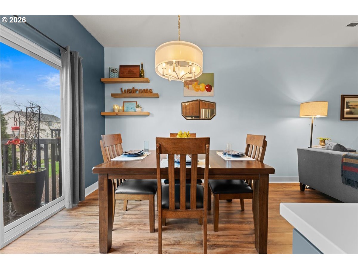 21123 Osburn Loop Fairview, OR 97024 - Photo 13 of 48 a view of a dining room with furniture and chandelier