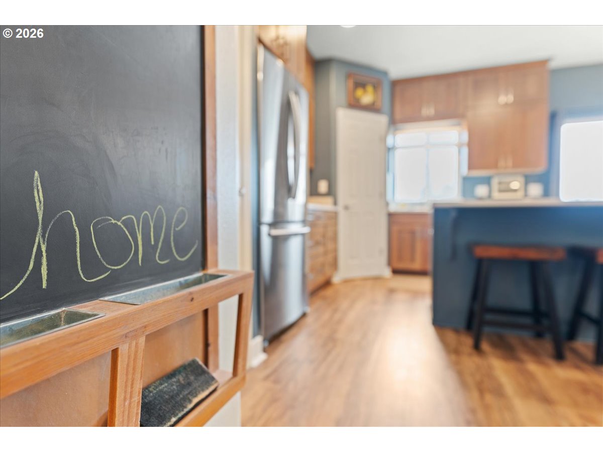21123 Osburn Loop Fairview, OR 97024 - Photo 16 of 48 a kitchen with stainless steel appliances granite countertop a refrigerator a sink dishwasher with wooden floor