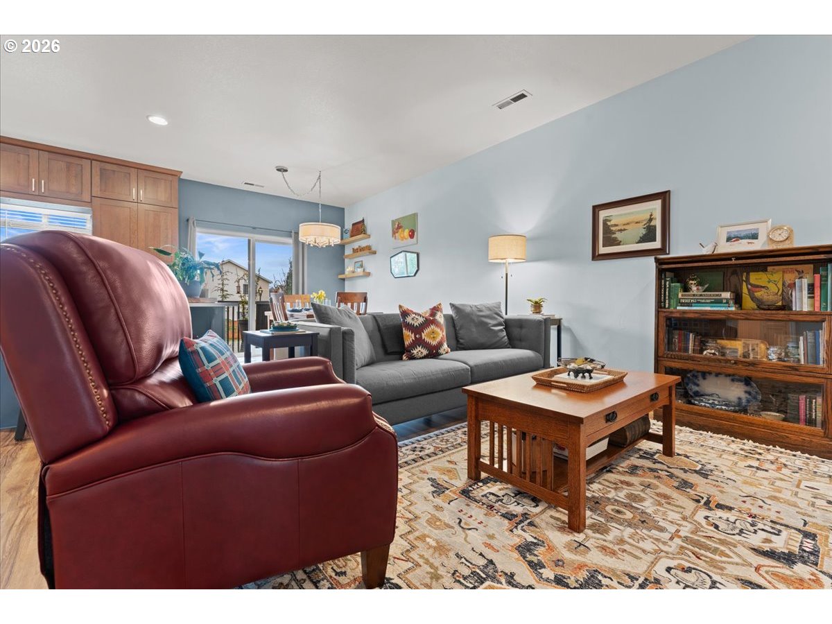 21123 Osburn Loop Fairview, OR 97024 - Photo 17 of 48 a living room with furniture a rug and a bookshelf