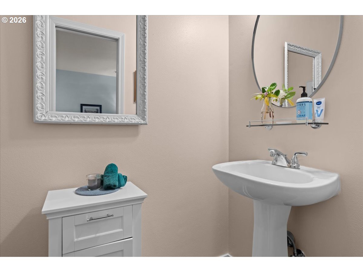 21123 Osburn Loop Fairview, OR 97024 - Photo 23 of 48 a bathroom with a sink a mirror and a potted plant