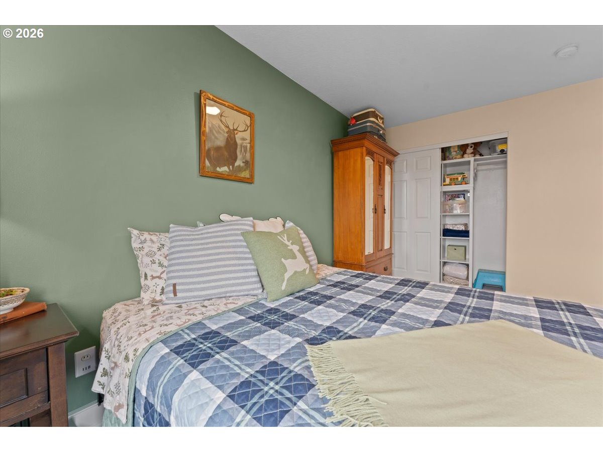 21123 Osburn Loop Fairview, OR 97024 - Photo 38 of 48 a bedroom with a bed and a flat screen tv