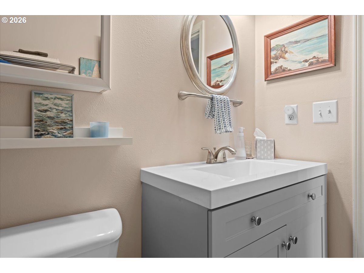 21123 Osburn Loop Fairview, OR 97024 - Photo 40 of 48 a bathroom with a toilet a sink and mirror