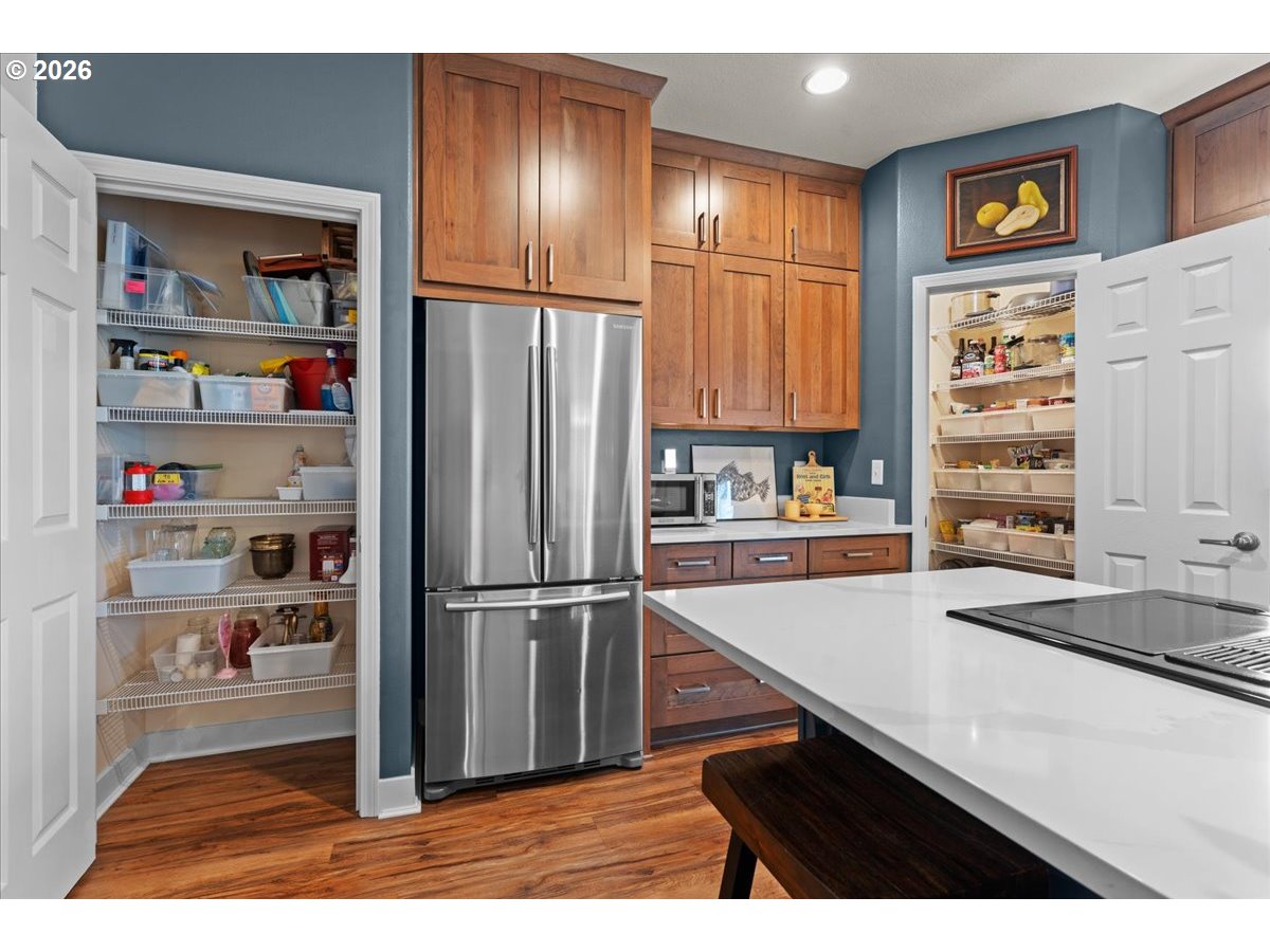 21123 Osburn Loop Fairview, OR 97024 - Photo 8 of 48 a kitchen with stainless steel appliances cabinets and a refrigerator